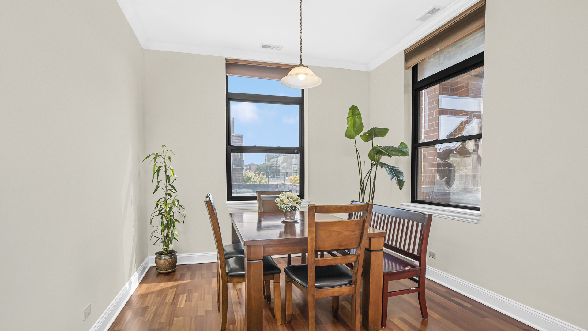 1908 West Irving Park Road, Unit 301 Chicago, IL 60613 - Photo 8 of 24 a view of a dining room with furniture and a potted plant