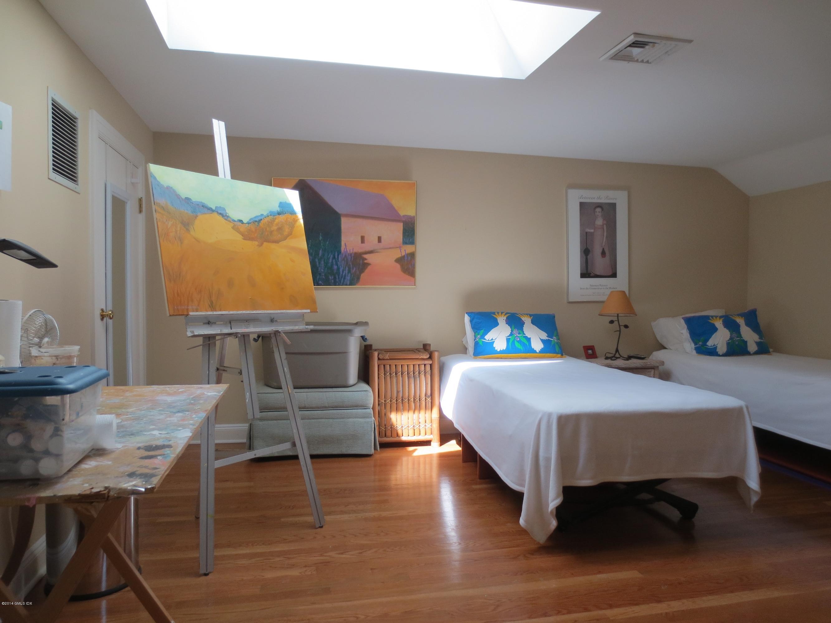 333 Palmer Hill Road, Unit 1D Riverside, CT 06878 - Photo 12 of 12 a bedroom with a bed and wooden floor