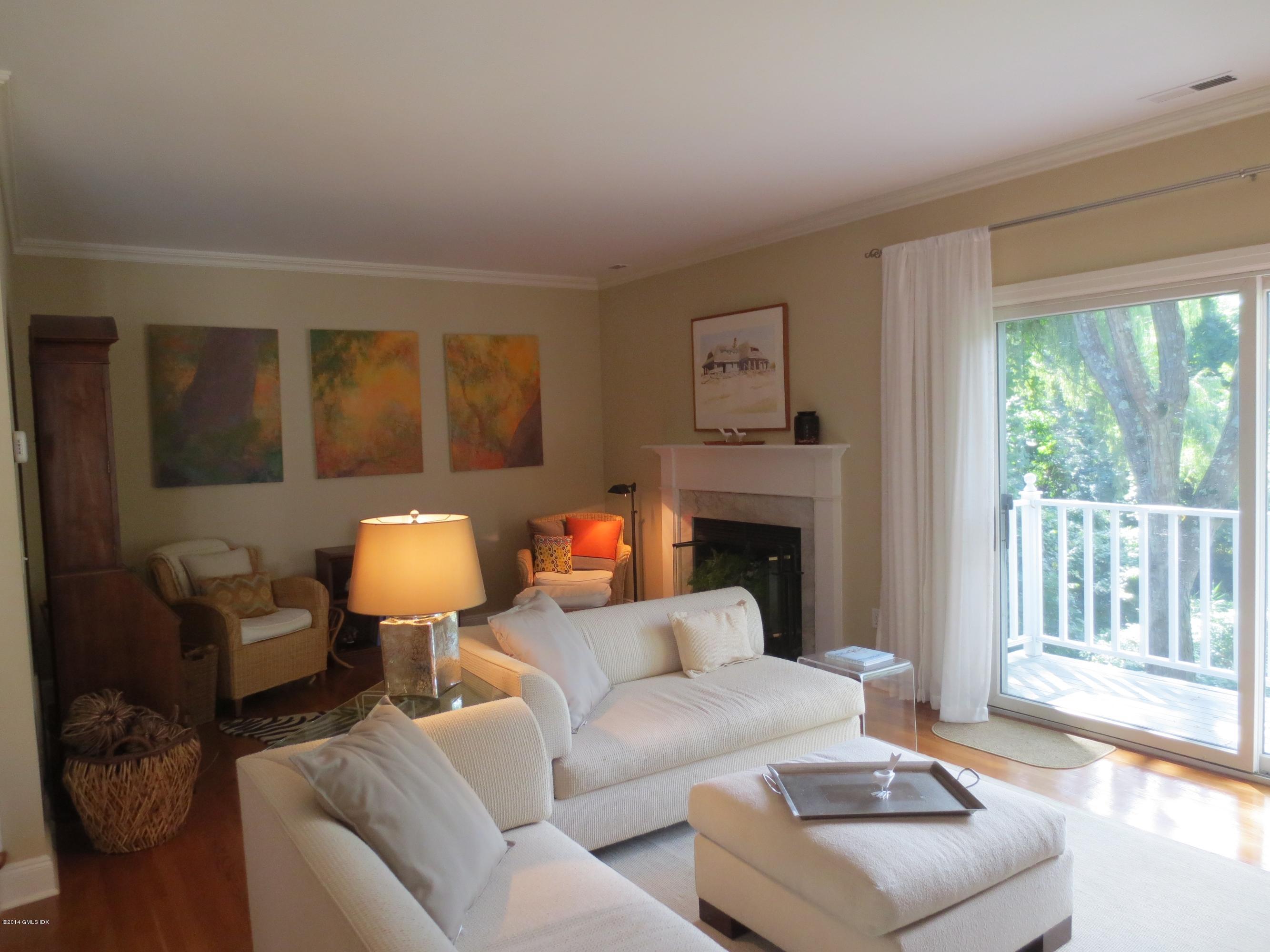 333 Palmer Hill Road, Unit 1D Riverside, CT 06878 - Photo 3 of 12 a living room with furniture a fireplace and a large window