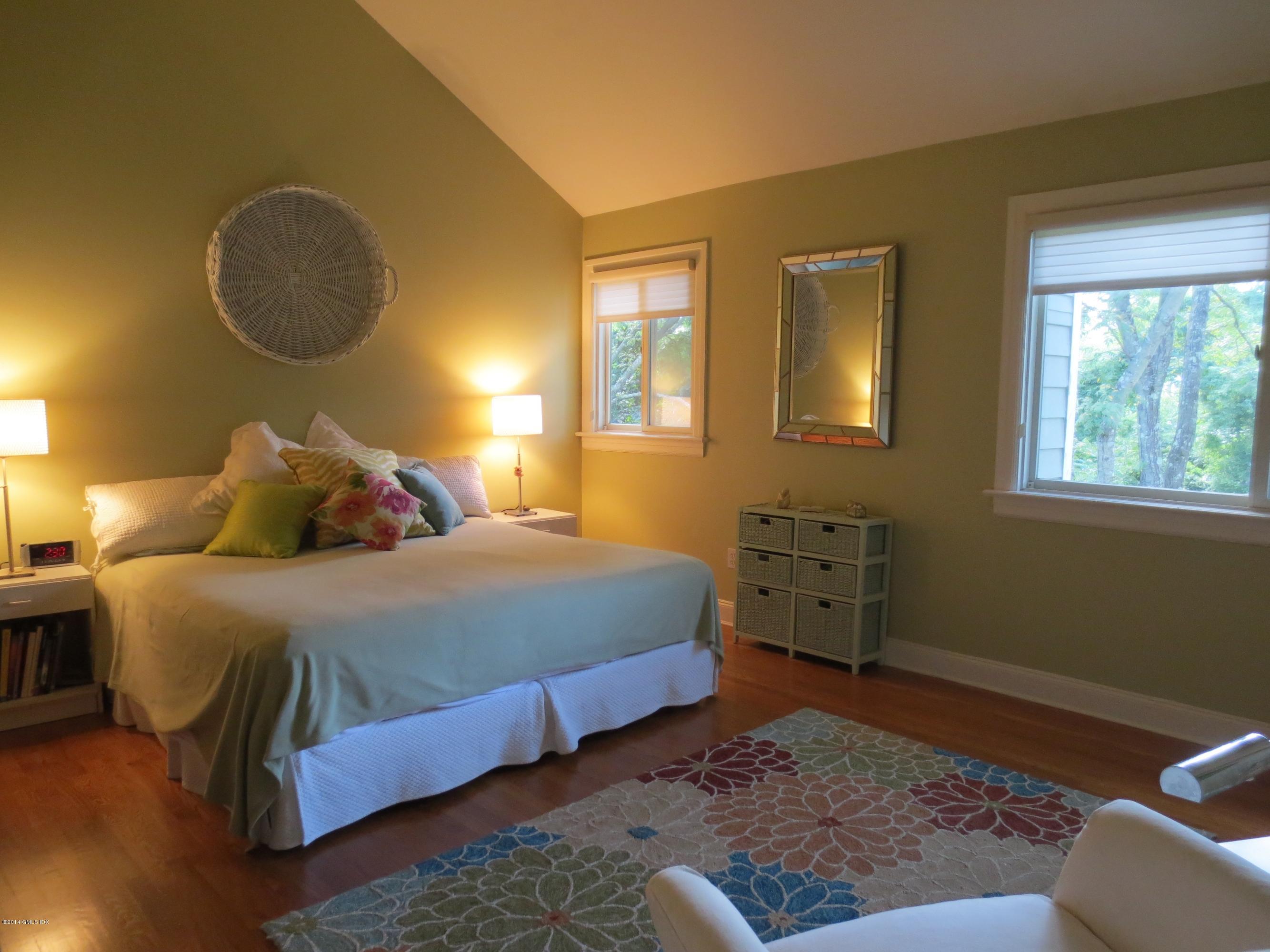 333 Palmer Hill Road, Unit 1D Riverside, CT 06878 - Photo 7 of 12 a bedroom with a bed and cabinets