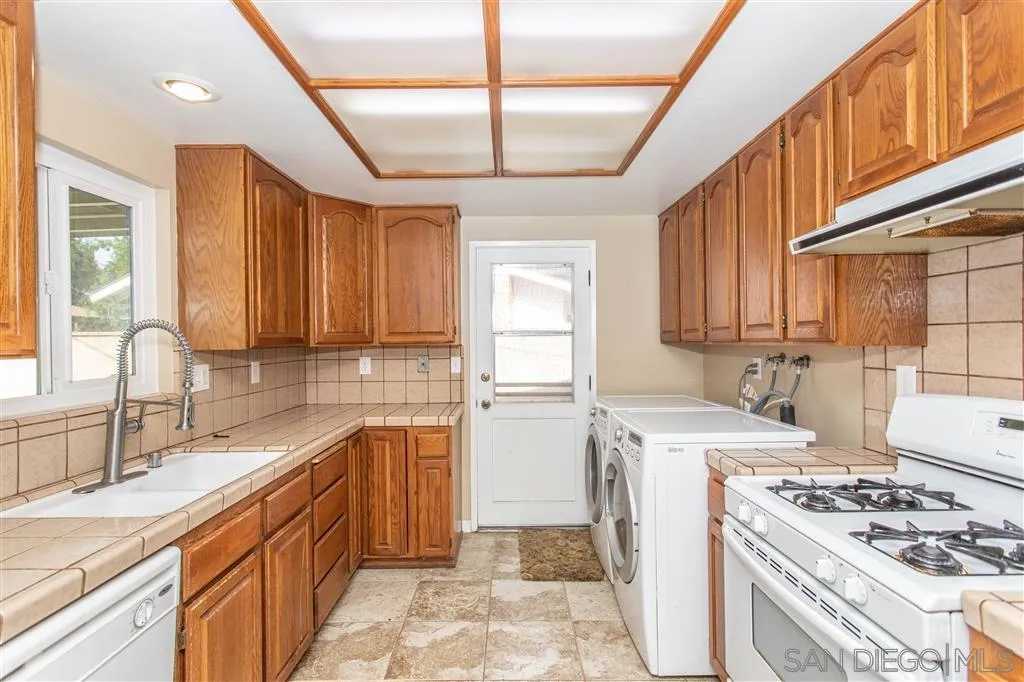 5939 Normandie Place Riverside, CA 92506 - Photo 17 of 21 a kitchen with a sink stove and cabinets