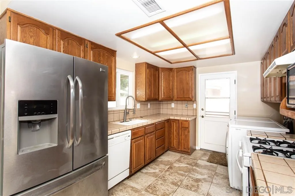 5939 Normandie Place Riverside, CA 92506 - Photo 18 of 21 a kitchen with stainless steel appliances granite countertop a refrigerator and a stove