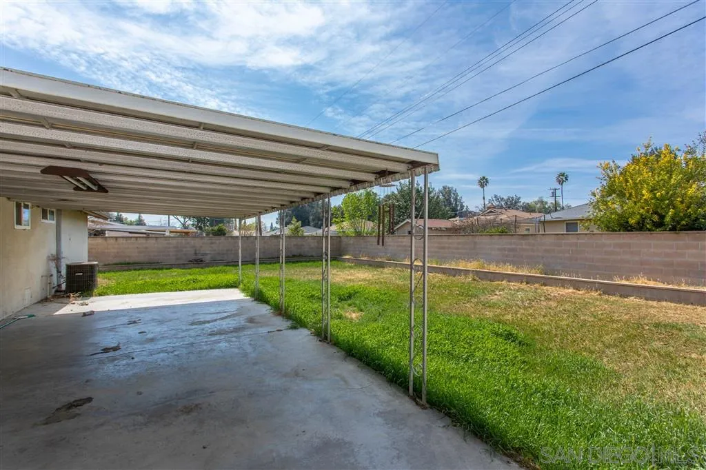 5939 Normandie Place Riverside, CA 92506 - Photo 19 of 21 a view of a backyard with table and chairs under an umbrella