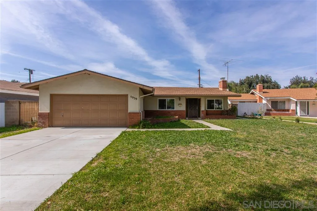 5939 Normandie Place Riverside, CA 92506 - Photo 2 of 21 a front view of a house with a yard and garage