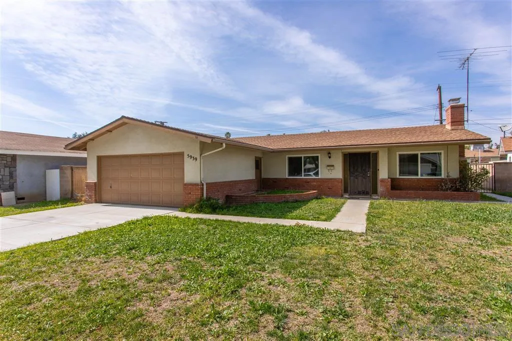 5939 Normandie Place Riverside, CA 92506 - Photo 3 of 21 a front view of a house with a yard and garage