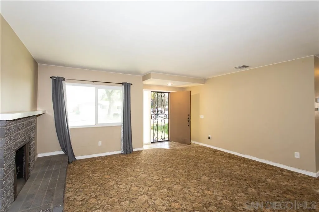 5939 Normandie Place Riverside, CA 92506 - Photo 5 of 21 a view of an empty room with a fireplace and a window