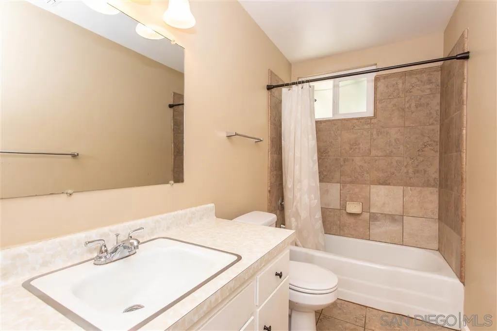 5939 Normandie Place Riverside, CA 92506 - Photo 7 of 21 a bathroom with a sink a toilet and shower
