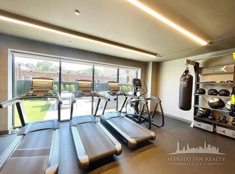 144-74 Northern Boulevard, Unit PHJ Queens, NY 11354 - Photo 13 of 13 a view of a room with gym equipment