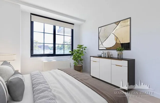 a bedroom with a bed and a potted plant