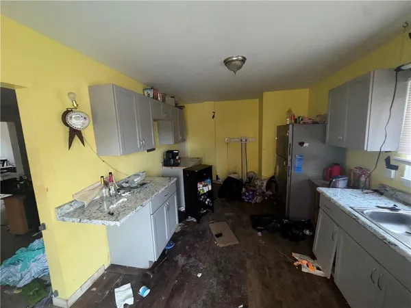a kitchen with a sink stove and refrigerator