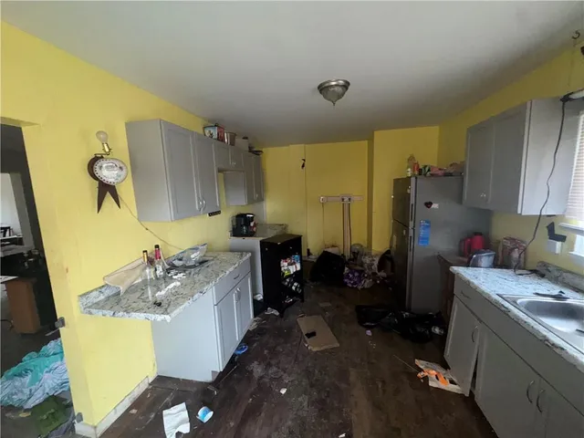 a kitchen with a sink stove and refrigerator