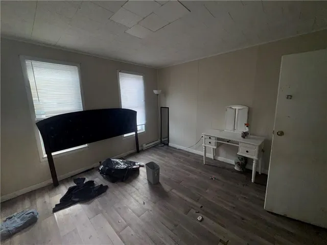 a living room with furniture wooden floor and a window