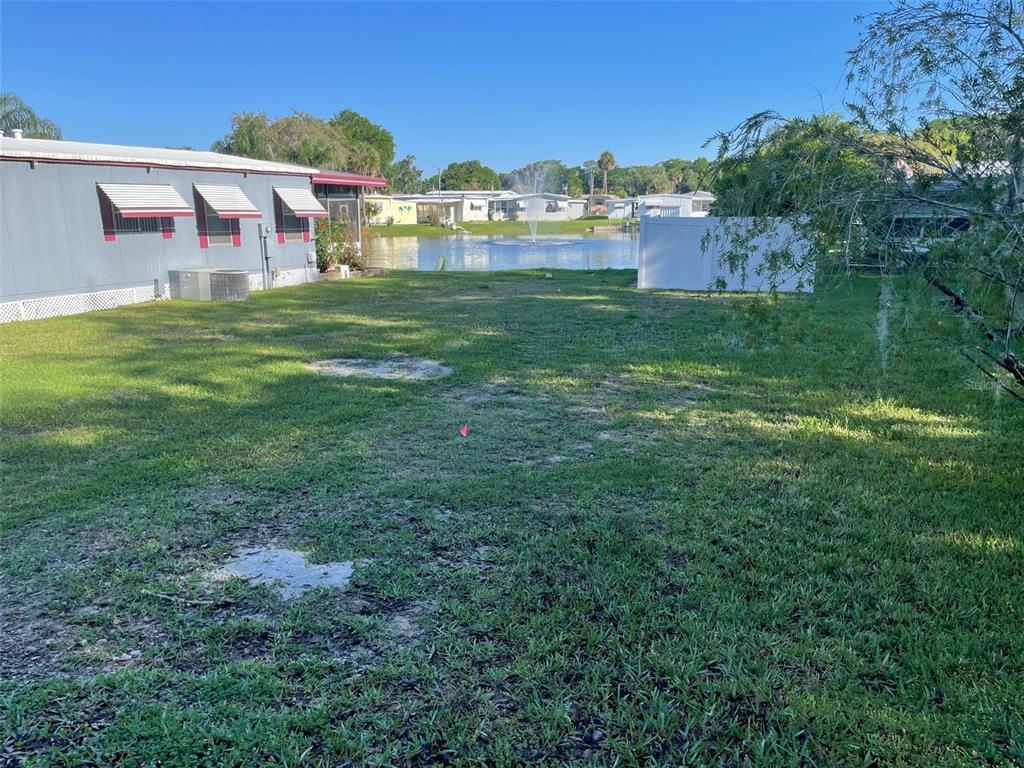 204 Allyson Road Leesburg, FL 34788 - Photo 2 of 3 a view of a big yard with a house in the background