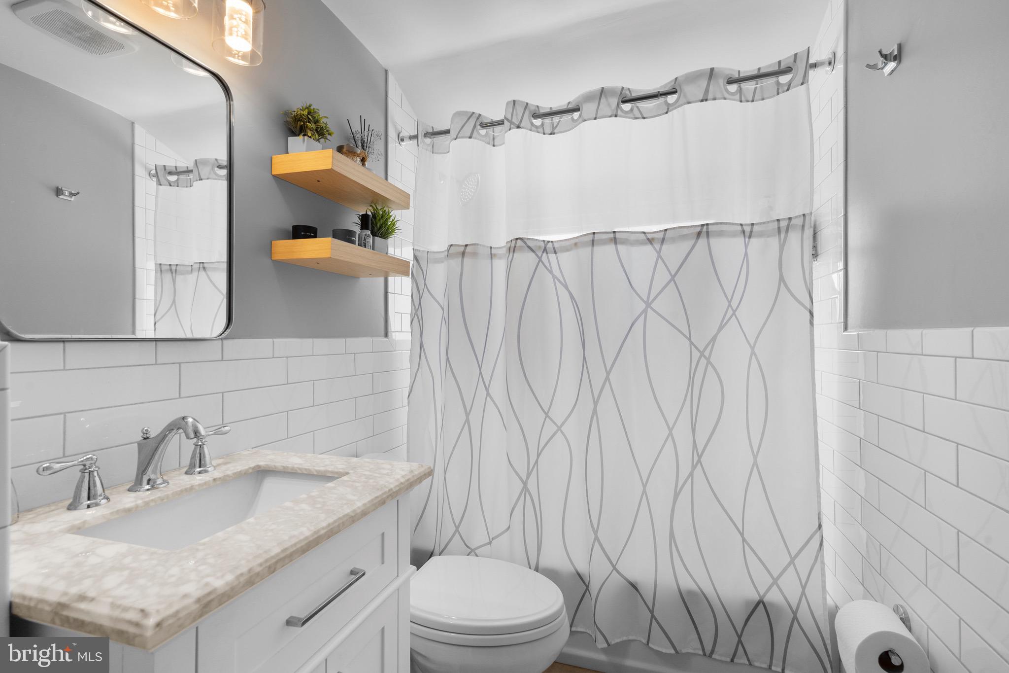 9 Honey Locust Road Levittown, PA 19056 - Photo 14 of 34 a bathroom with a granite countertop sink and a mirror