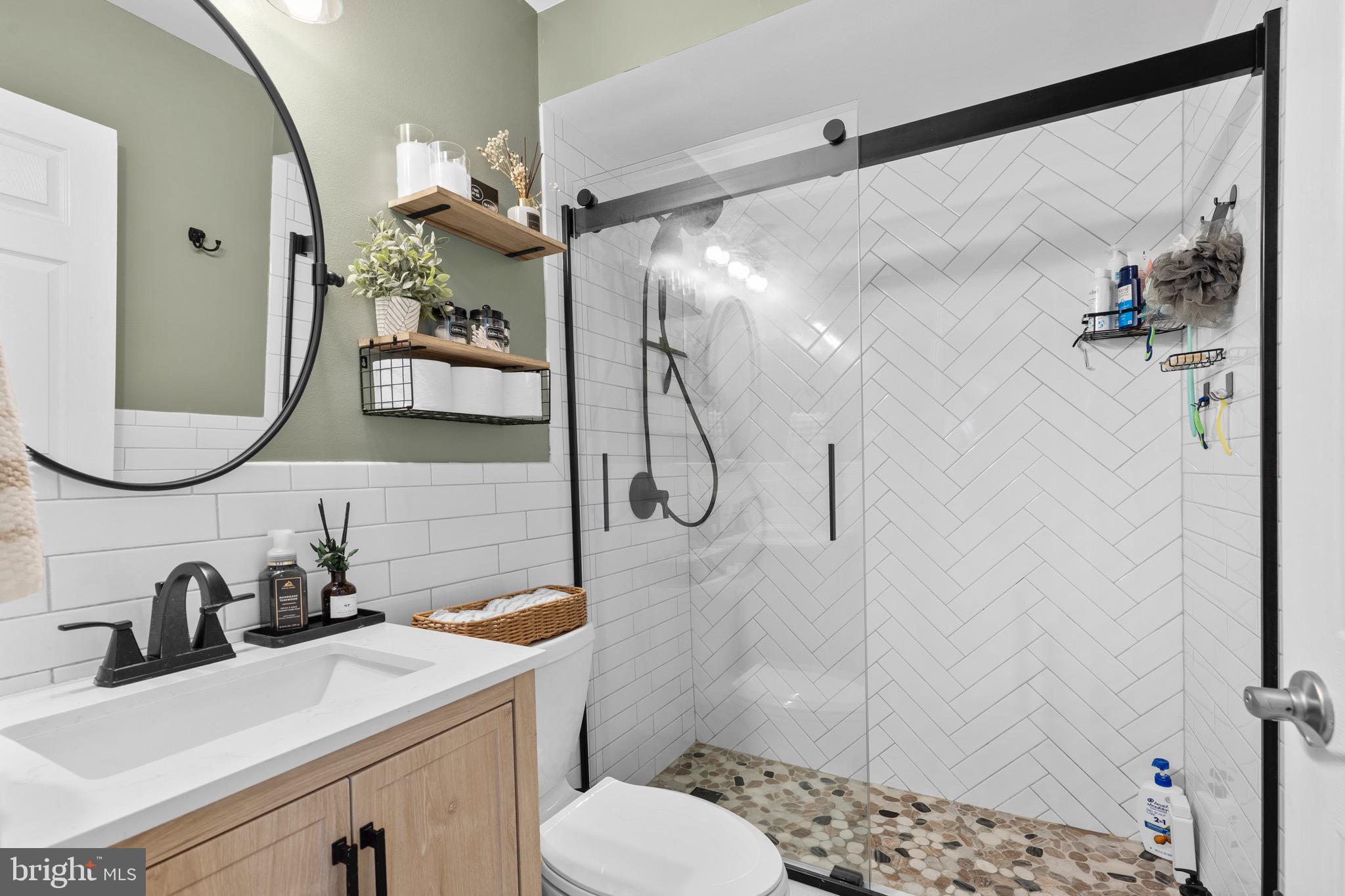 9 Honey Locust Road Levittown, PA 19056 - Photo 15 of 34 a bathroom with a sink vanity mirror and toilet