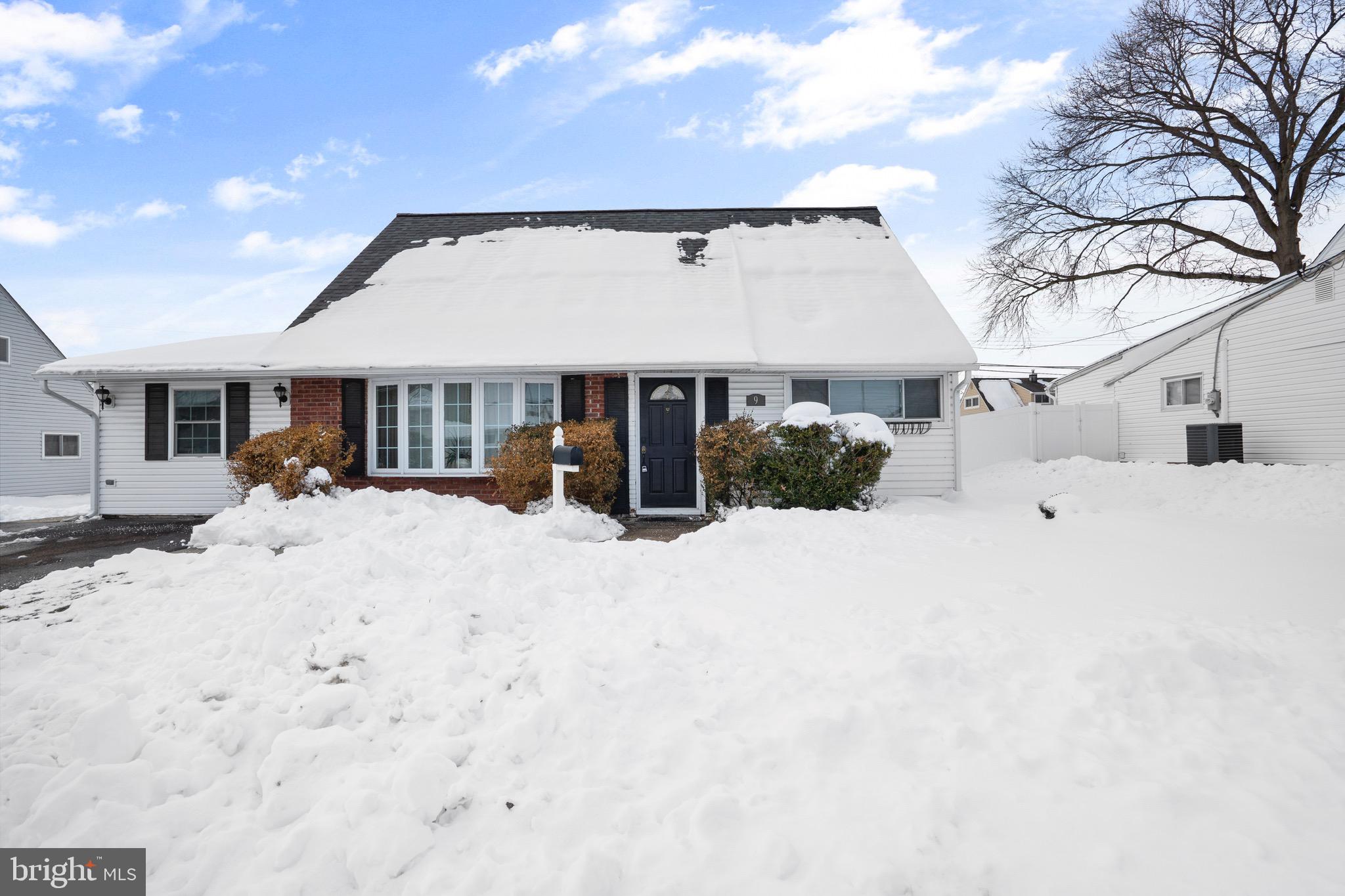 9 Honey Locust Road Levittown, PA 19056 - Photo 28 of 34 a view of a white house with a snow in the background