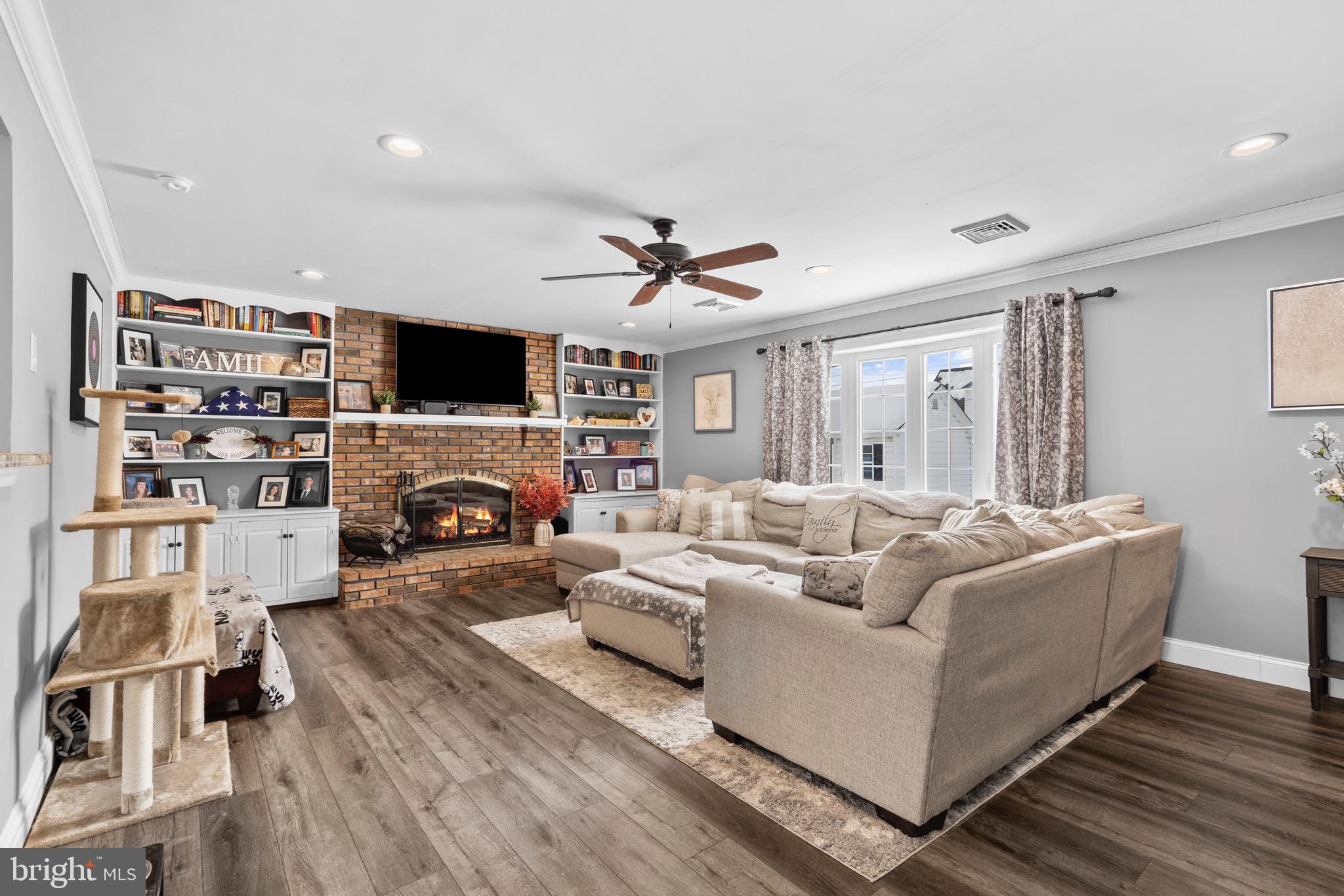 9 Honey Locust Road Levittown, PA 19056 - Photo 3 of 34 a living room with furniture a fireplace and a flat screen tv