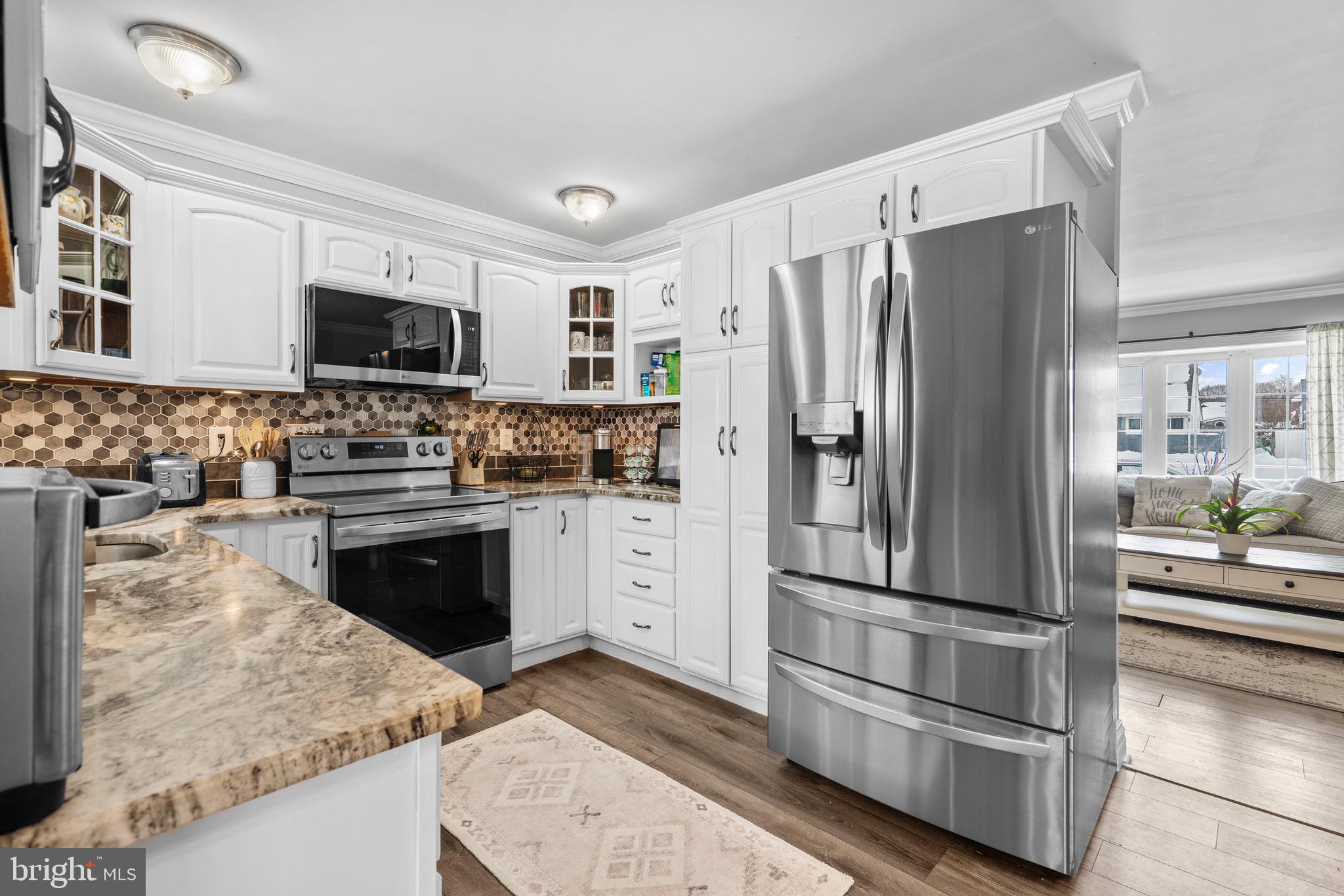 9 Honey Locust Road Levittown, PA 19056 - Photo 4 of 34 a kitchen with stainless steel appliances granite countertop a refrigerator stove and microwave