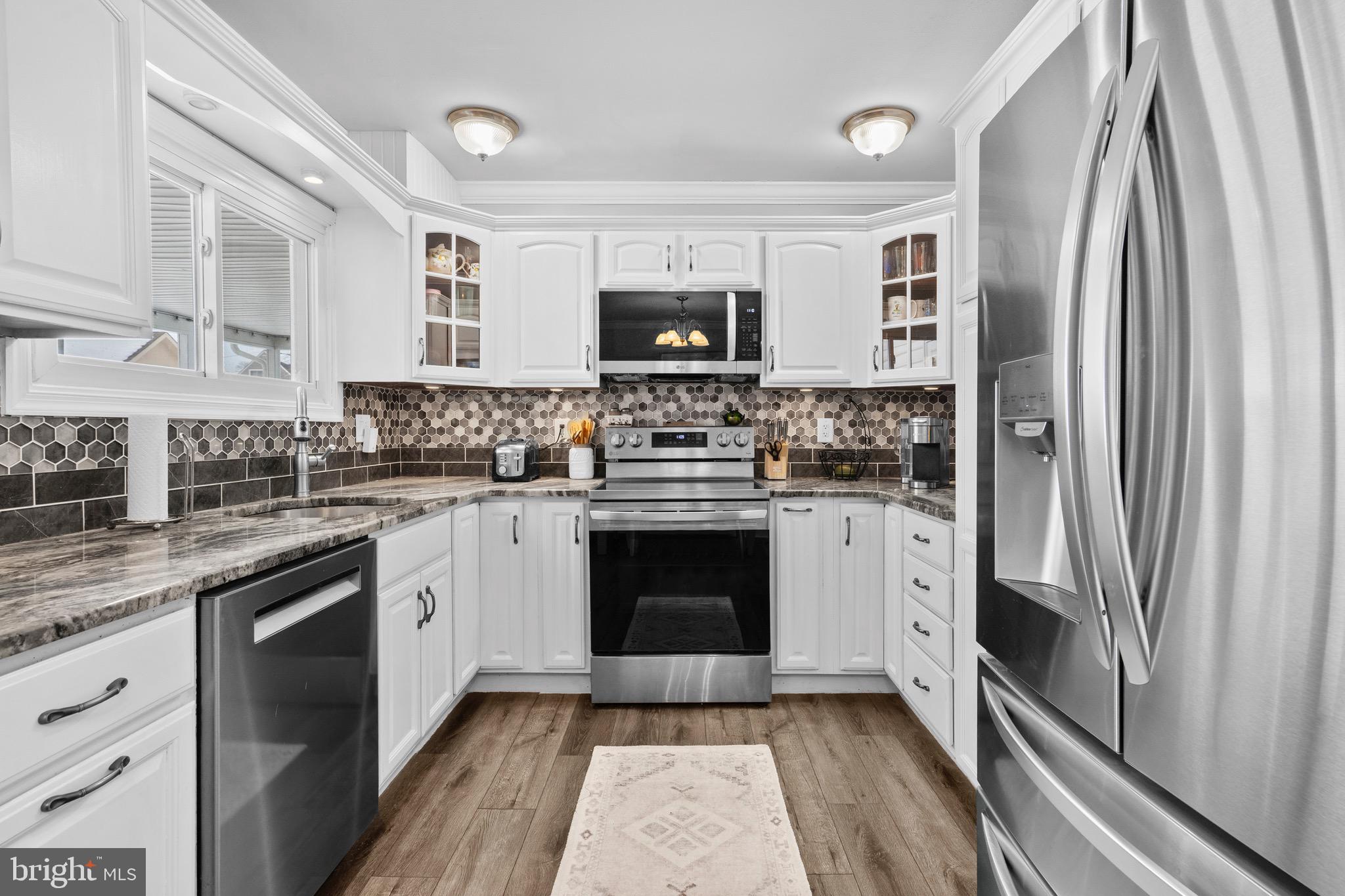 9 Honey Locust Road Levittown, PA 19056 - Photo 5 of 34 a kitchen with stainless steel appliances a stove sink and refrigerator