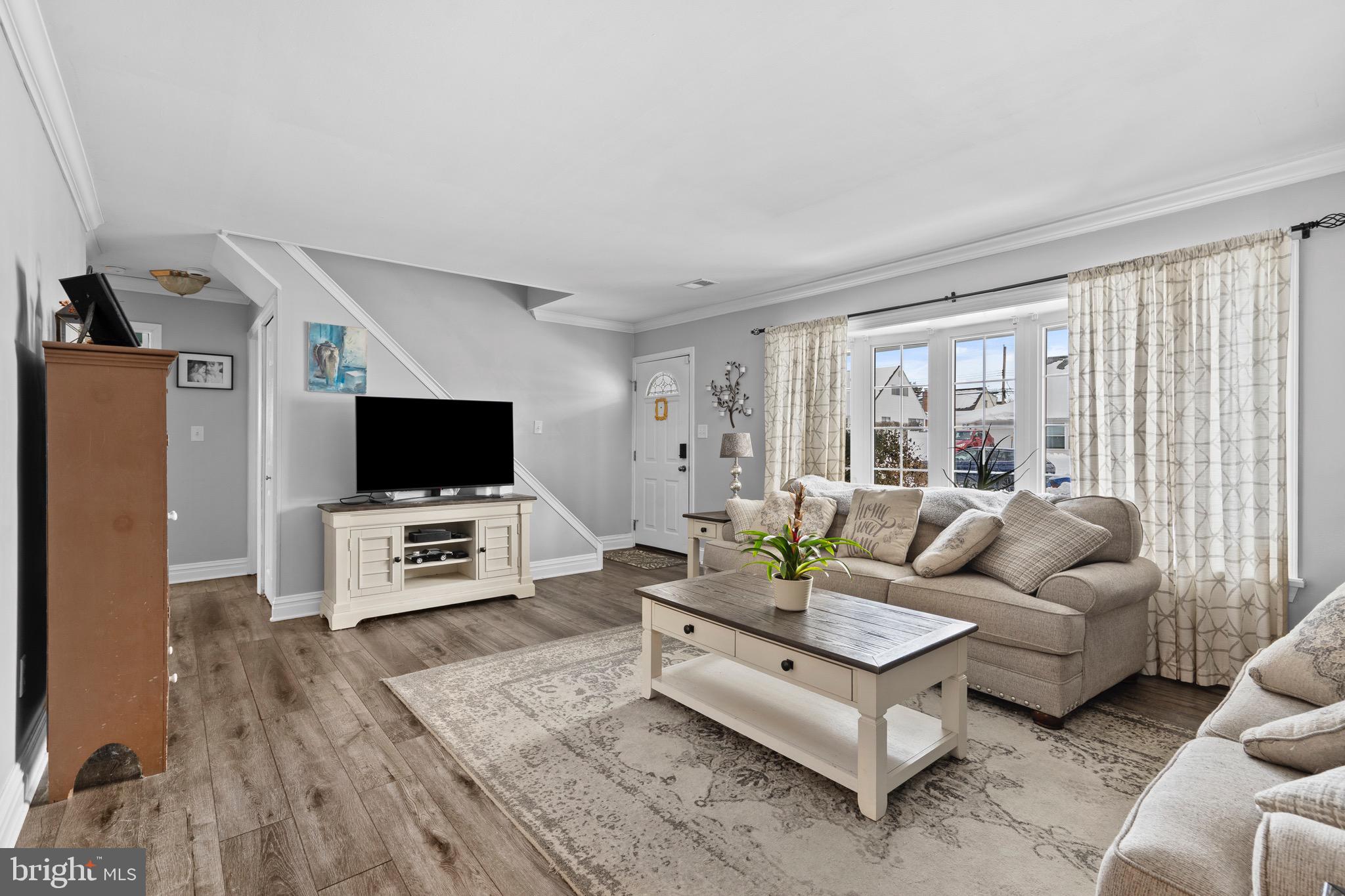 9 Honey Locust Road Levittown, PA 19056 - Photo 8 of 34 a living room with furniture a flat screen tv and a large window