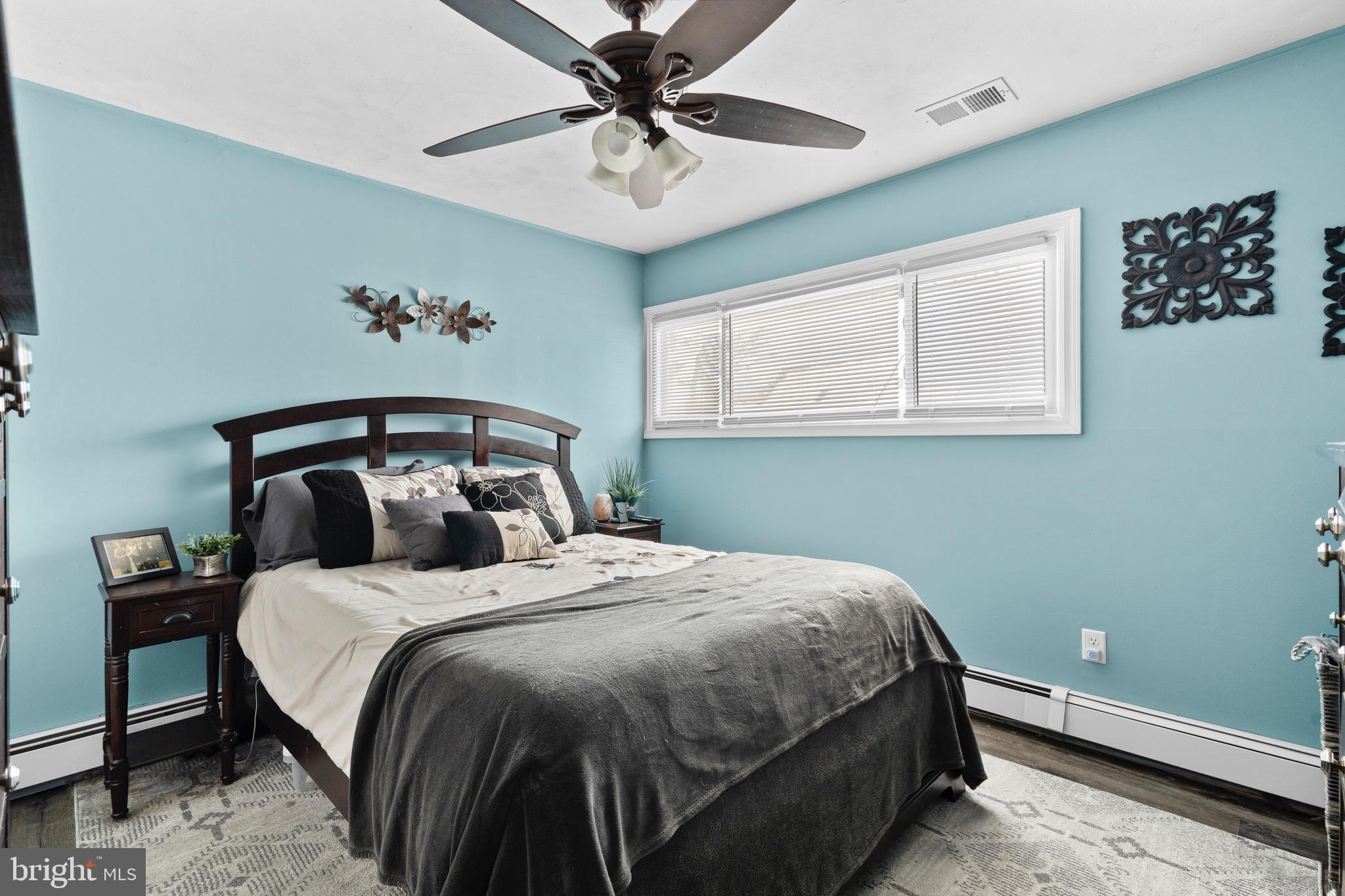 9 Honey Locust Road Levittown, PA 19056 - Photo 10 of 34 a bedroom with a bed and a chandelier