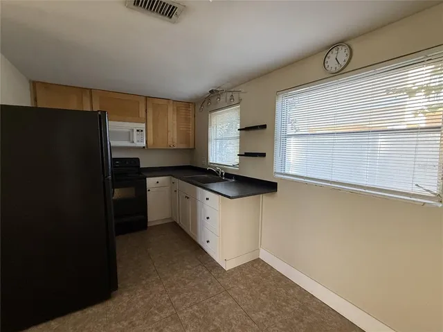 a kitchen with a refrigerator and a window