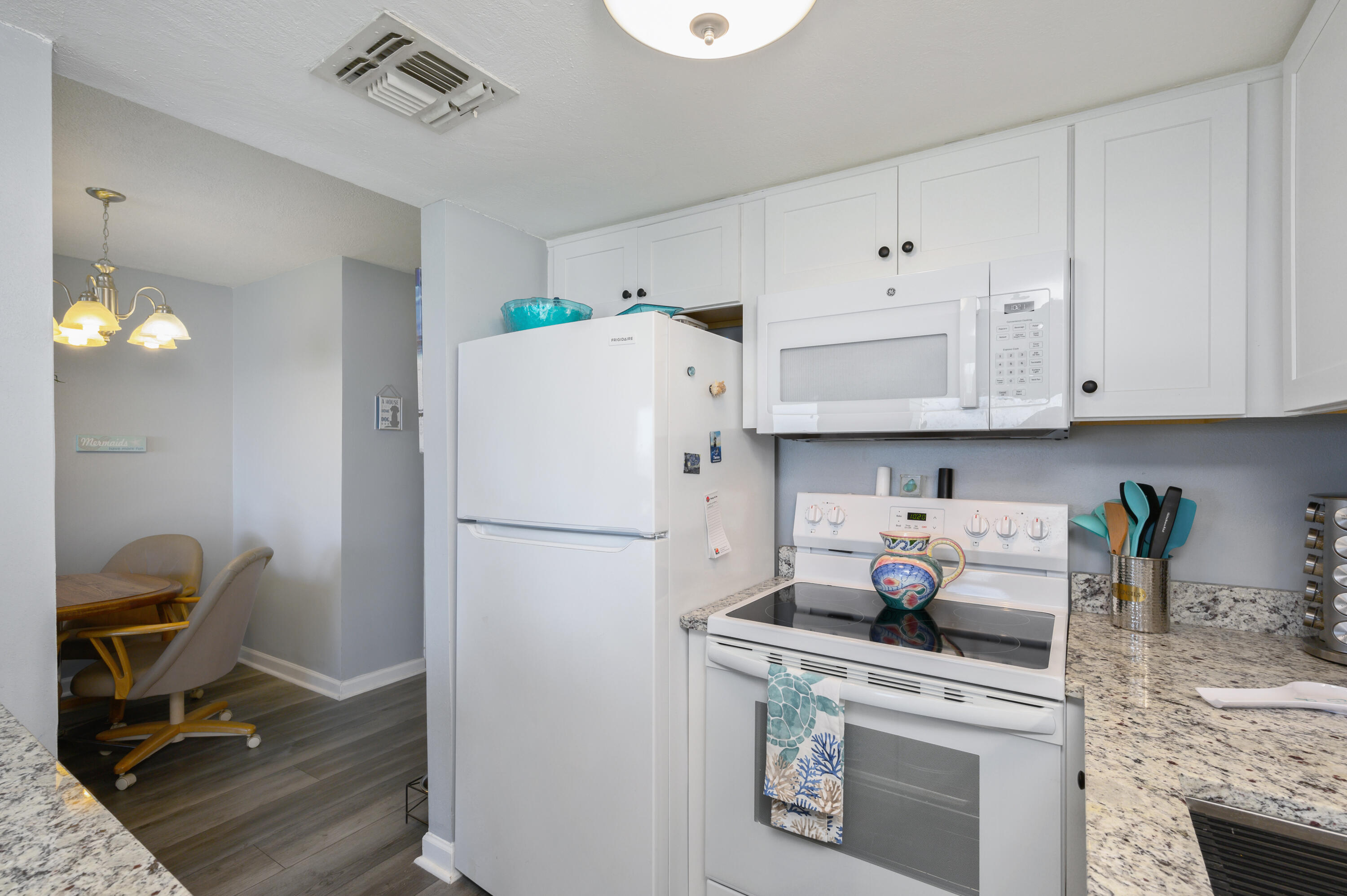 101 Old Ferry Road, Unit 16B Shalimar, FL 32579 - Photo 13 of 26 a white refrigerator freezer sitting inside of a kitchen