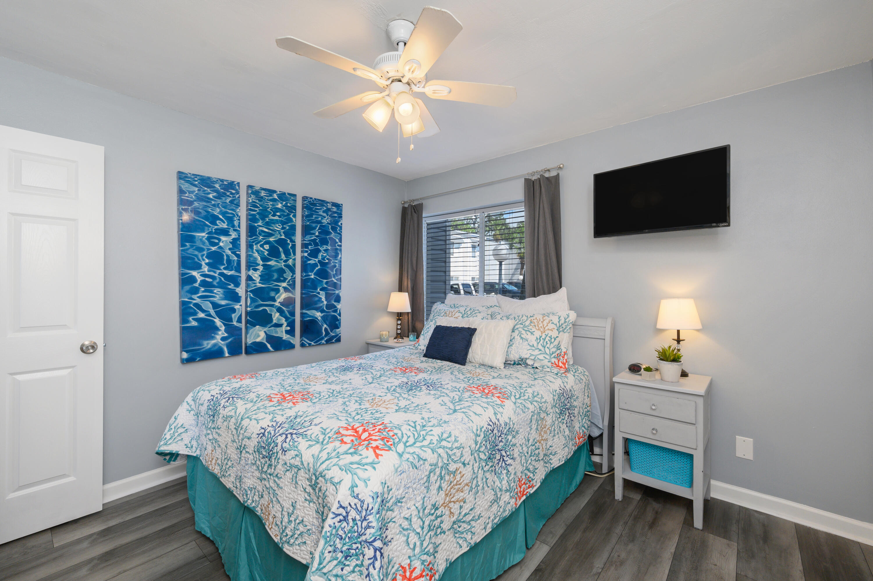 101 Old Ferry Road, Unit 16B Shalimar, FL 32579 - Photo 15 of 26 a bedroom with a bed a tv and wooden floor