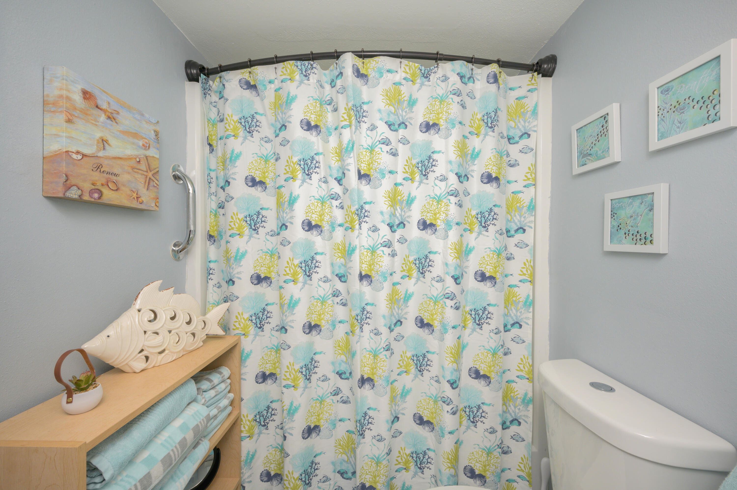 101 Old Ferry Road, Unit 16B Shalimar, FL 32579 - Photo 19 of 26 a bathroom with a toilet and a shower curtain