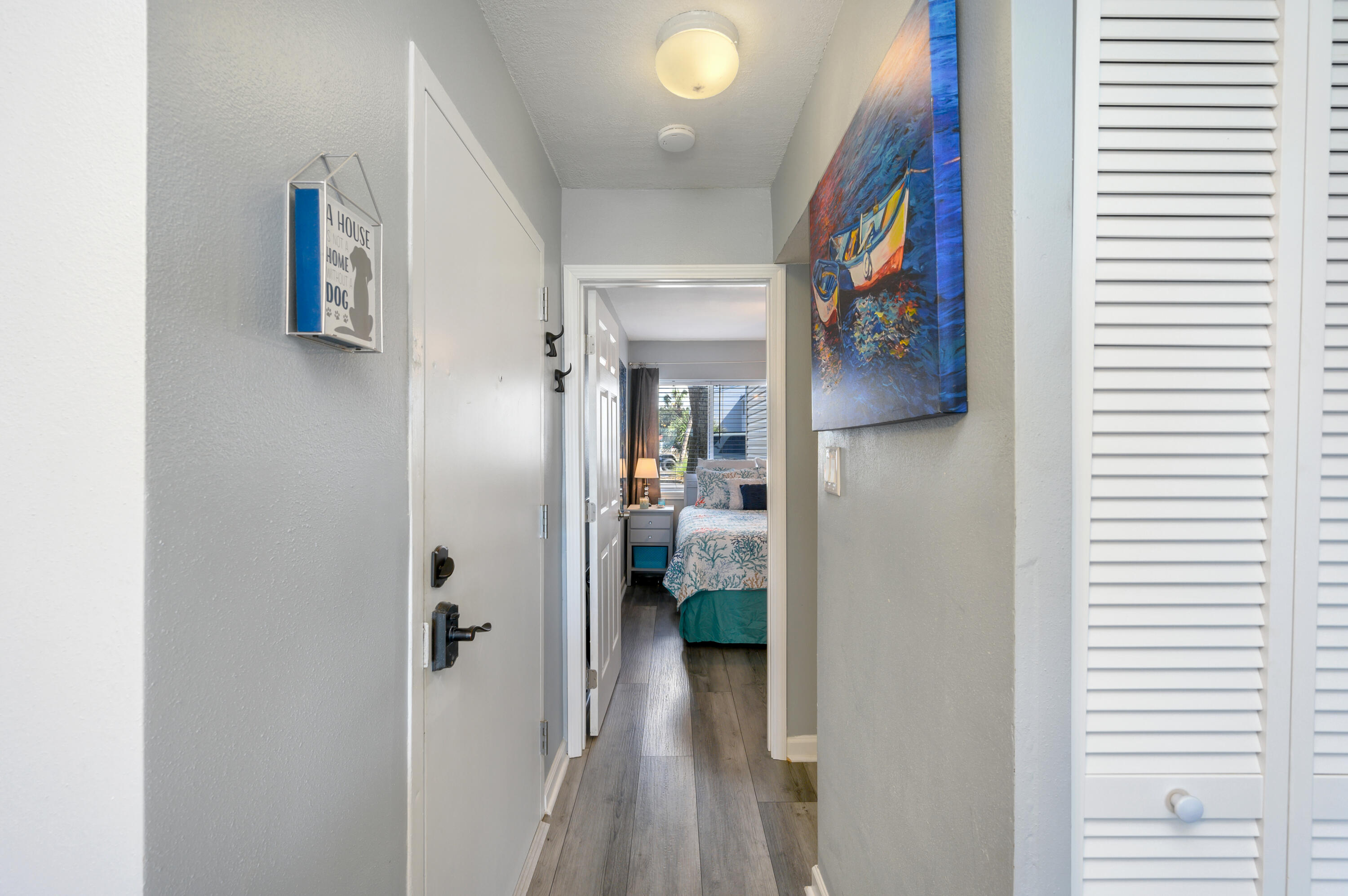 101 Old Ferry Road, Unit 16B Shalimar, FL 32579 - Photo 3 of 26 a view of a hallway with wooden floor and closet
