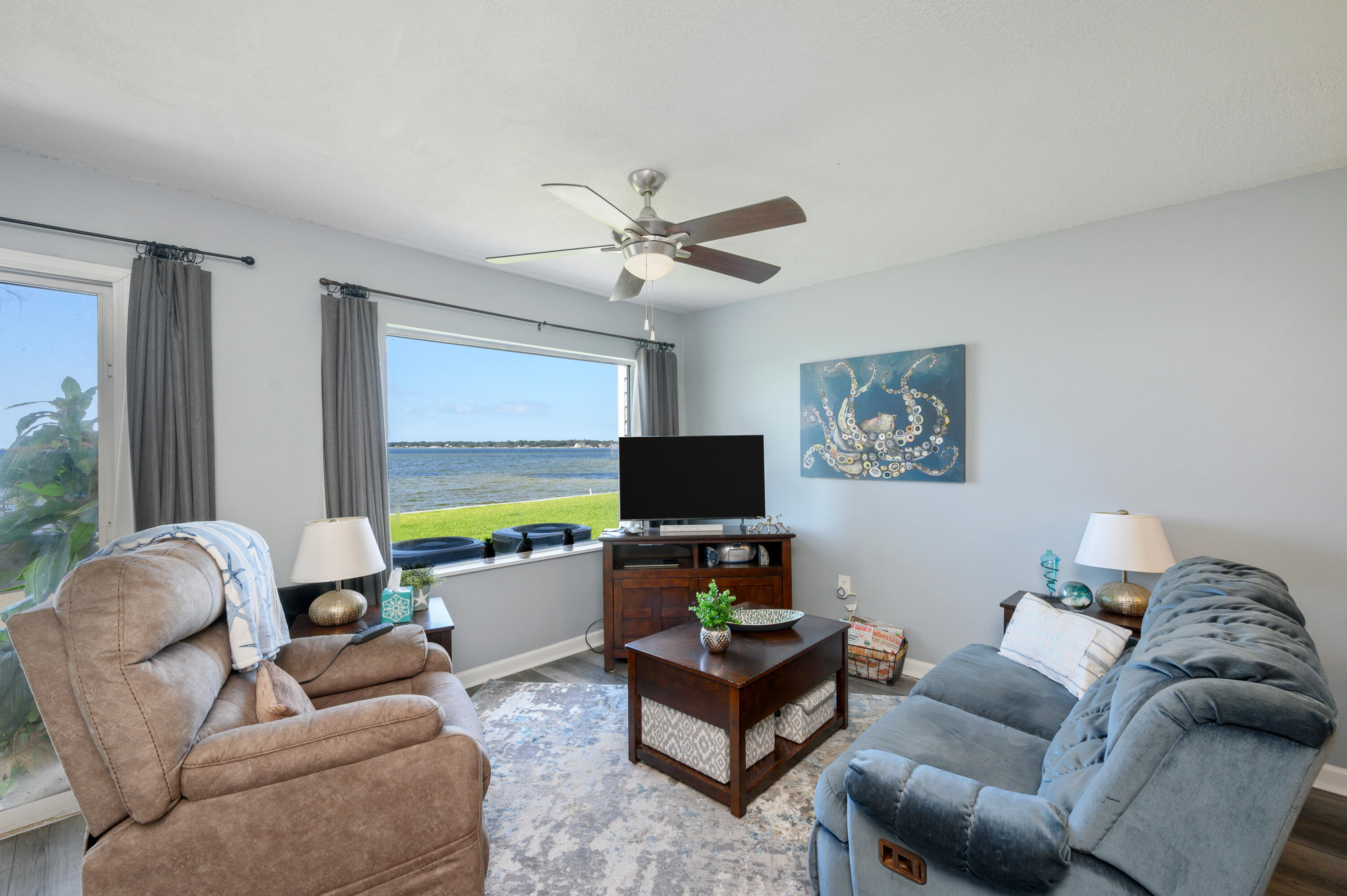 101 Old Ferry Road, Unit 16B Shalimar, FL 32579 - Photo 5 of 26 a living room with furniture and a flat screen tv
