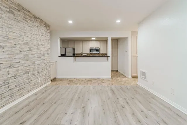 a room with a wooden floor and a sink
