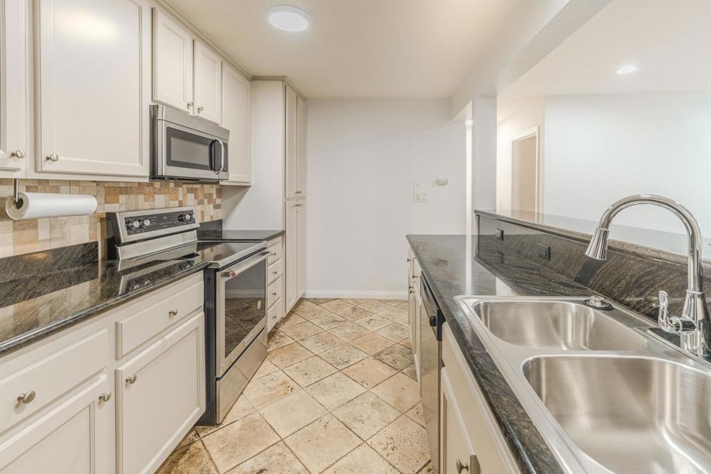 9860 Dale Avenue, Unit D10 Spring Valley, CA 91977 - Photo 14 of 55 a kitchen with stainless steel appliances granite countertop a sink stove and microwave