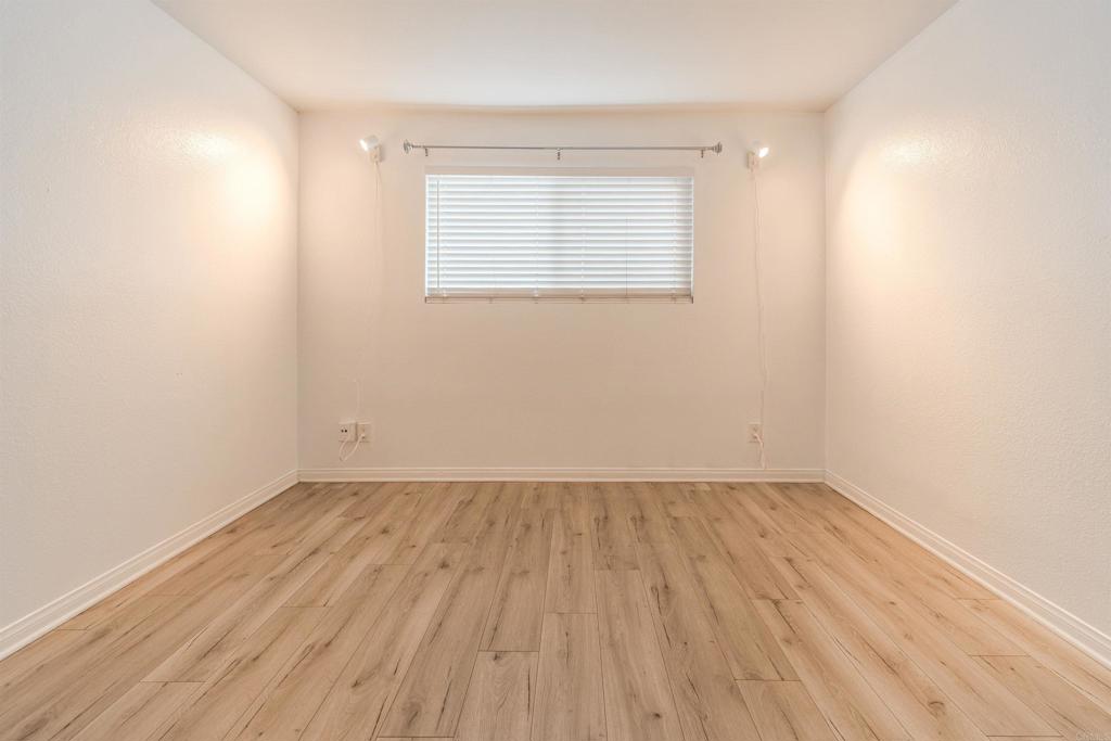 9860 Dale Avenue, Unit D10 Spring Valley, CA 91977 - Photo 17 of 55 an empty room with wooden floor and windows