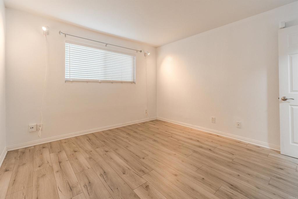 9860 Dale Avenue, Unit D10 Spring Valley, CA 91977 - Photo 18 of 55 an empty room with wooden floor and windows
