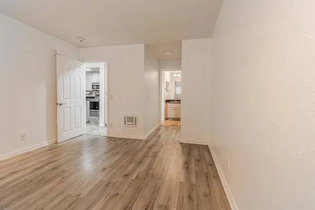 a view of a room with wooden floor