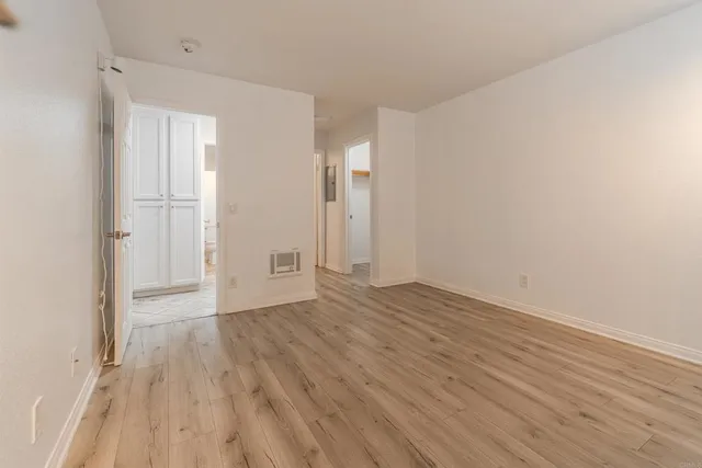 a view of an empty room and wooden floor