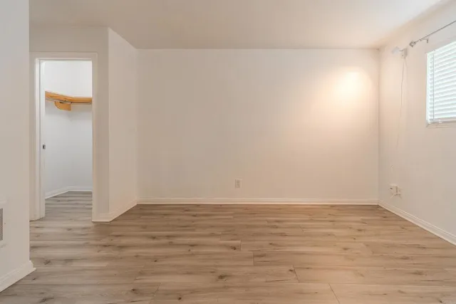 an empty room with wooden floor