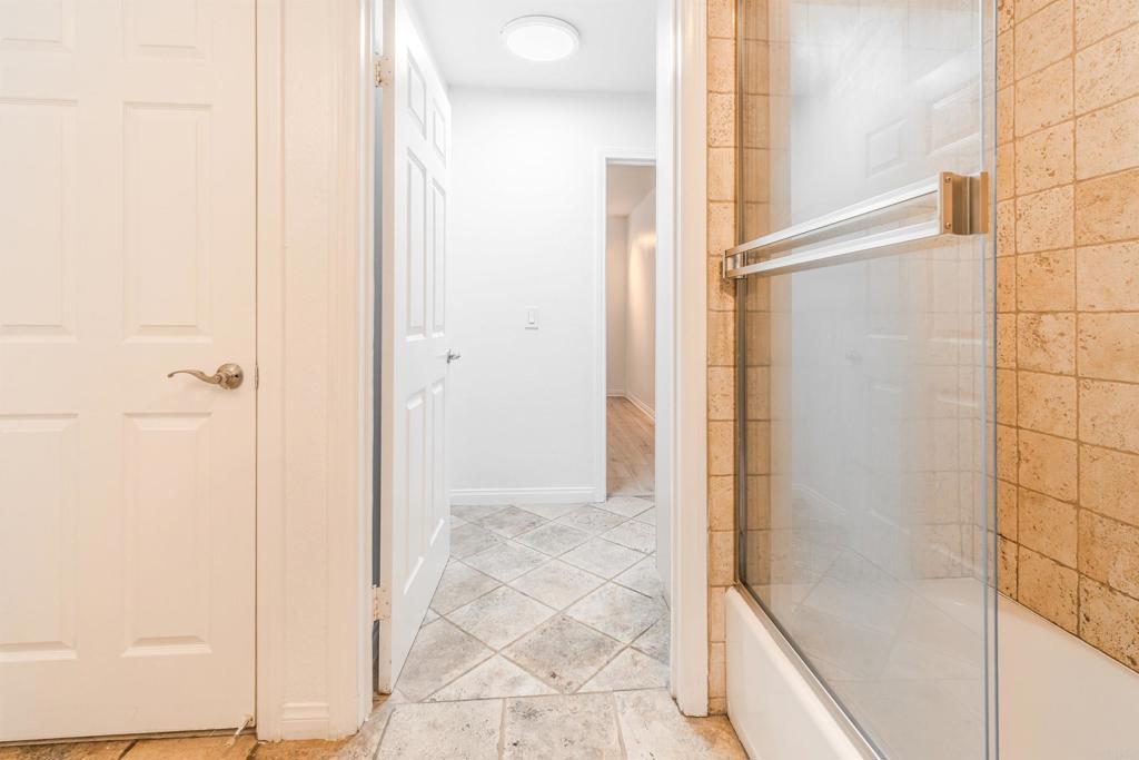 9860 Dale Avenue, Unit D10 Spring Valley, CA 91977 - Photo 32 of 55 a bathroom with a glass shower door