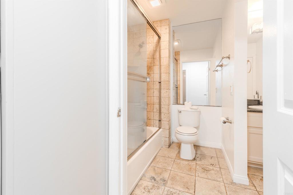 9860 Dale Avenue, Unit D10 Spring Valley, CA 91977 - Photo 33 of 55 a bathroom with a granite countertop toilet a sink and shower