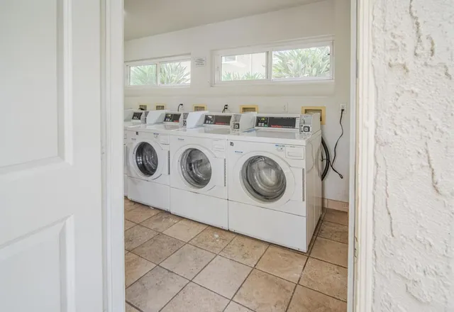 a utility room with multiple dryer and washer