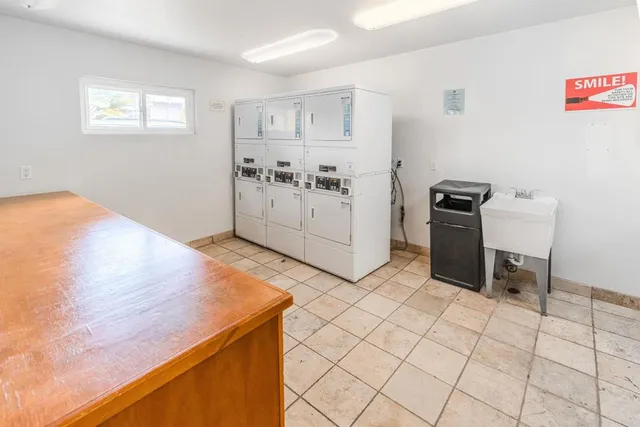 a swimming pool with lawn chairs and a yard