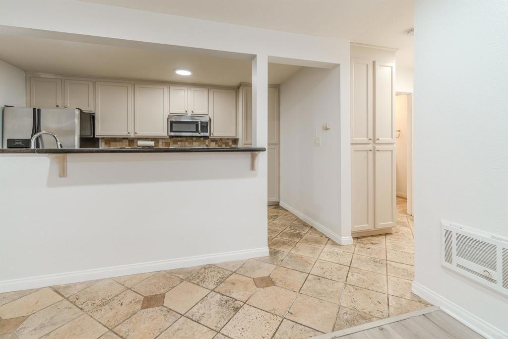 9860 Dale Avenue, Unit D10 Spring Valley, CA 91977 - Photo 5 of 55 a view of kitchen with granite countertop cabinets and refrigerator