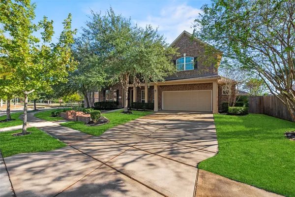 a view of a house with a yard and tree s