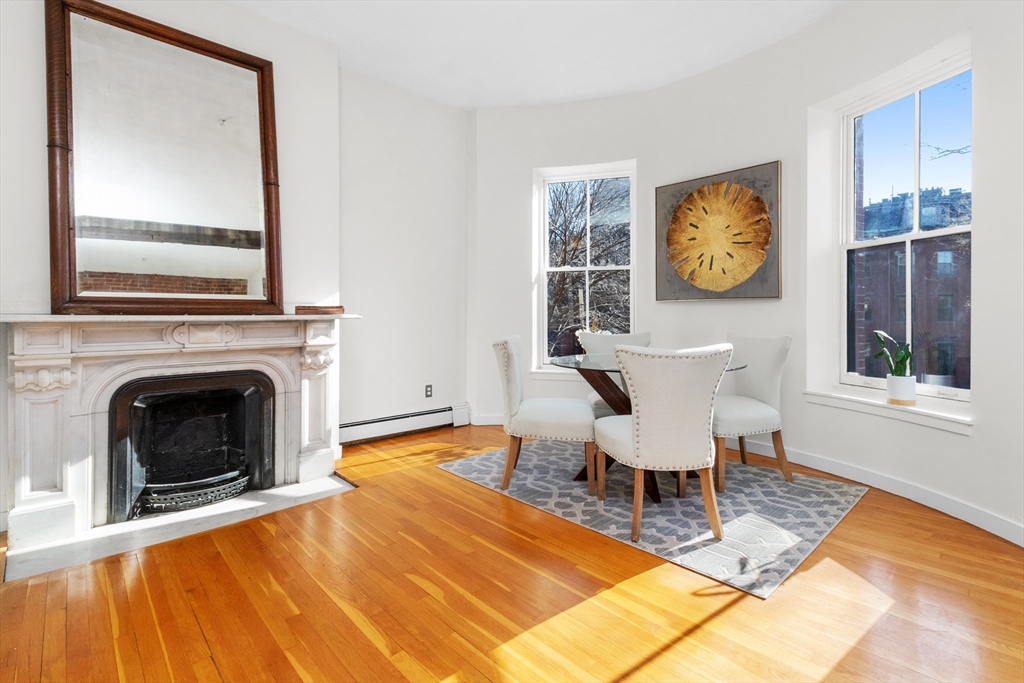 28 Worcester Square, Unit 3 Boston, MA 02118 - Photo 4 of 15 a living room with furniture a window and a fireplace