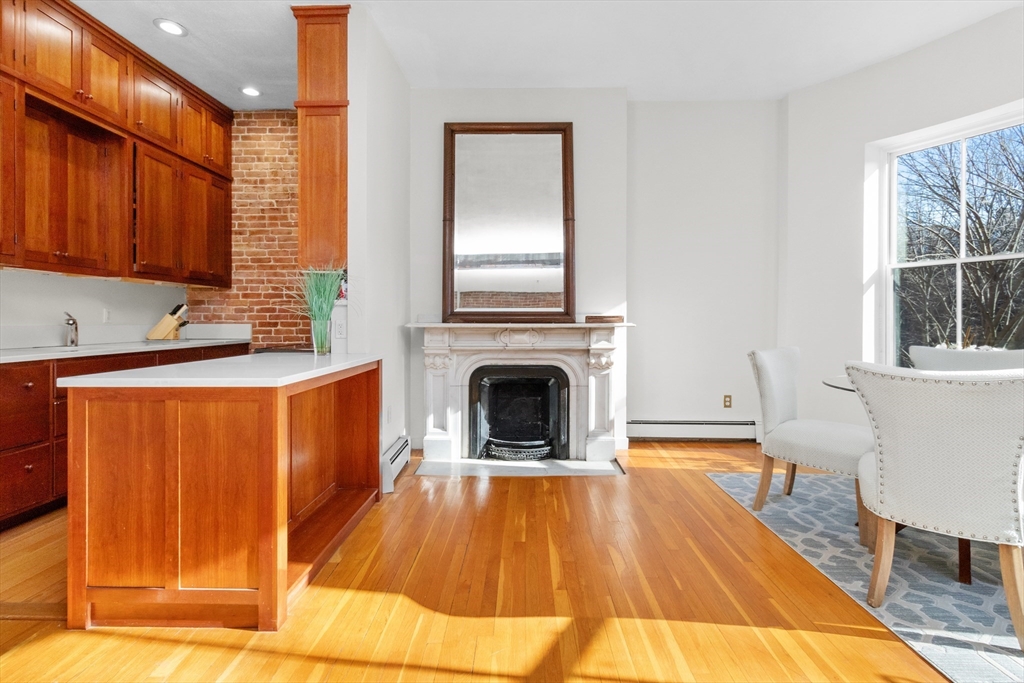 28 Worcester Square, Unit 3 Boston, MA 02118 - Photo 7 of 15 a living room with stainless steel appliances granite countertop furniture wooden floor and a window