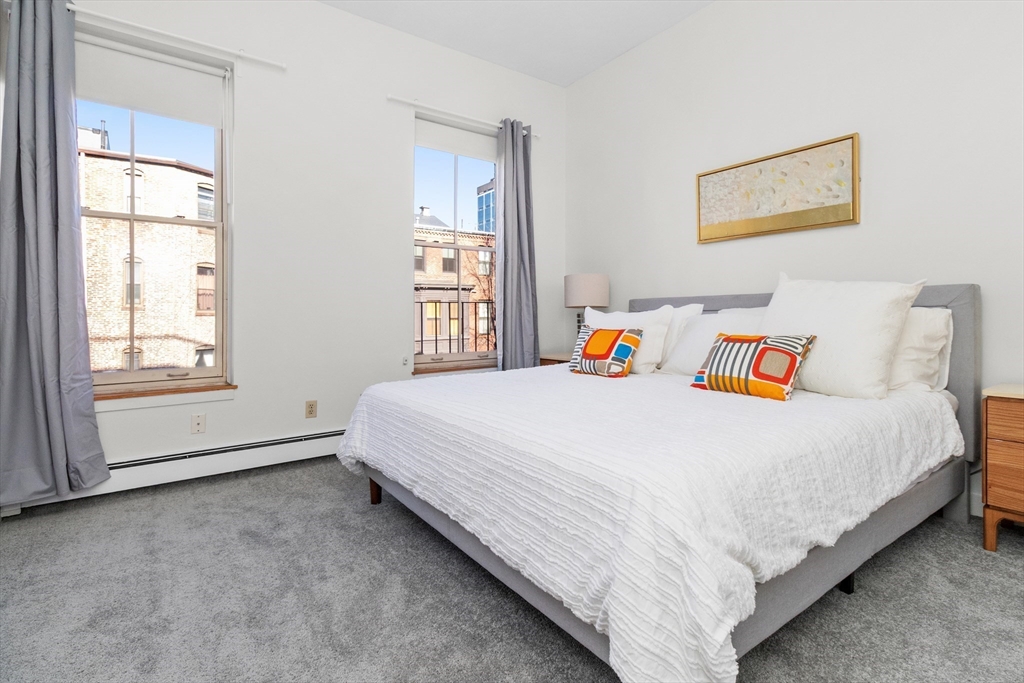 28 Worcester Square, Unit 3 Boston, MA 02118 - Photo 10 of 15 a bed sitting in a bedroom next to a window