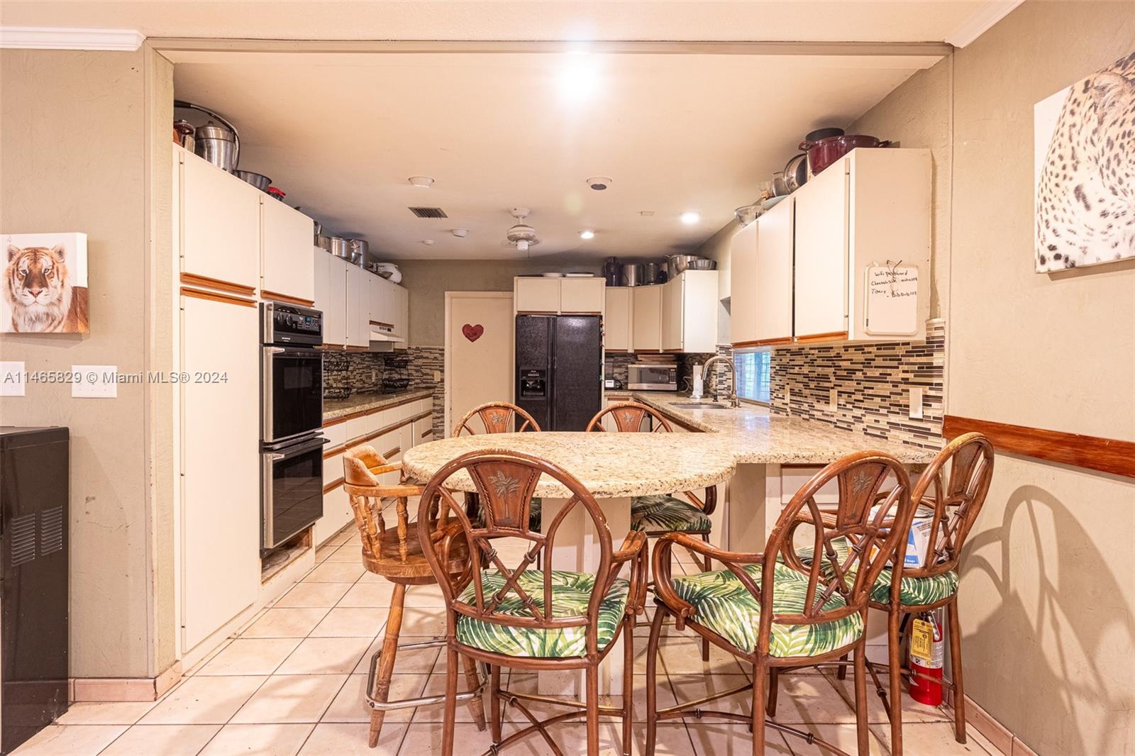 6000 Southwest 118th Avenue Miami, FL 33183 - Photo 11 of 49 a large kitchen with a table and chairs