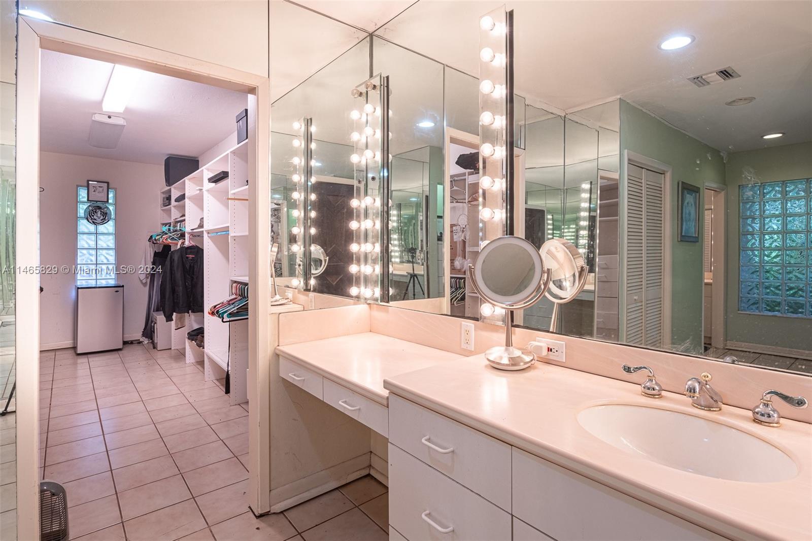 6000 Southwest 118th Avenue Miami, FL 33183 - Photo 19 of 49 a bathroom with a sink a vanity a mirror and shower