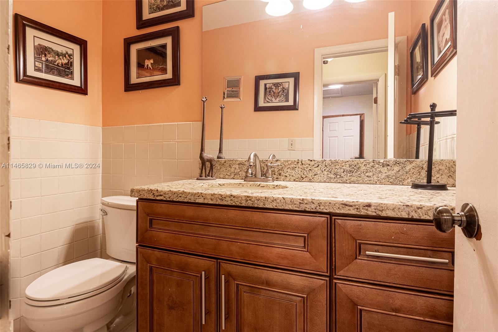 6000 Southwest 118th Avenue Miami, FL 33183 - Photo 21 of 49 a bathroom with a granite countertop toilet sink and mirror